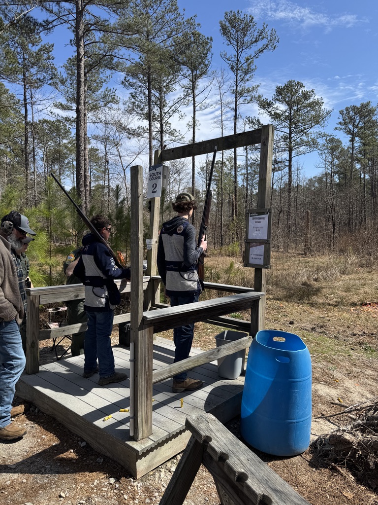 Two shooters at South Course station two with coaches watching from the platform
