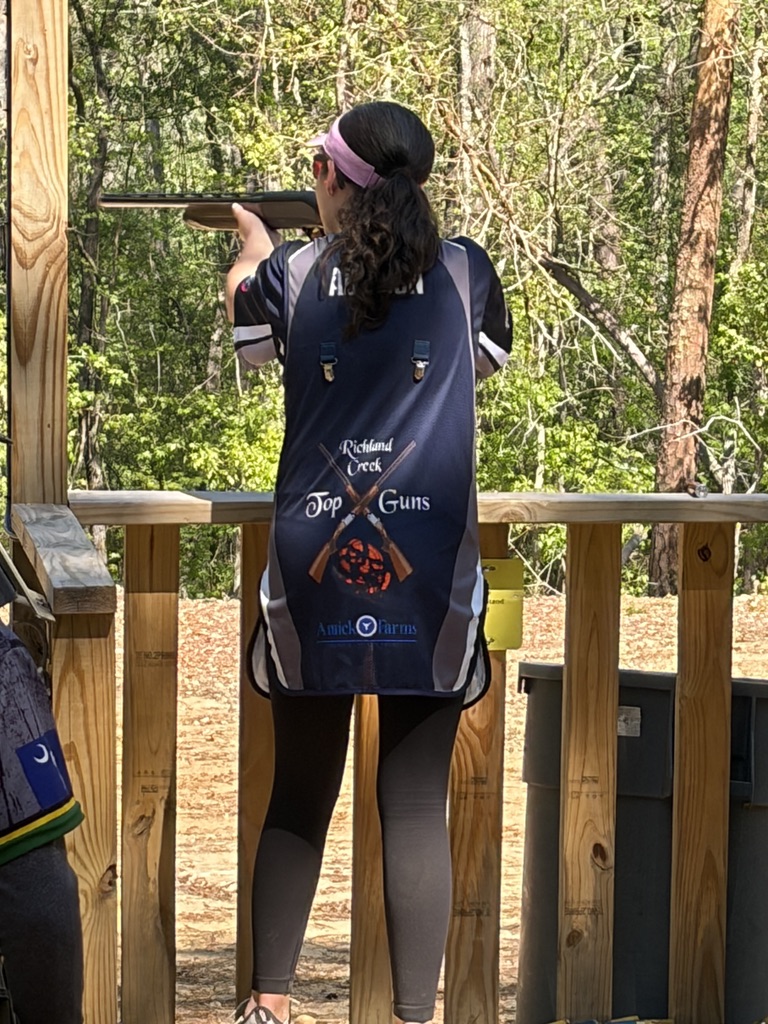 Shooter in a Richland Creek Top Guns vest mounted on a shotgun at a wooden station