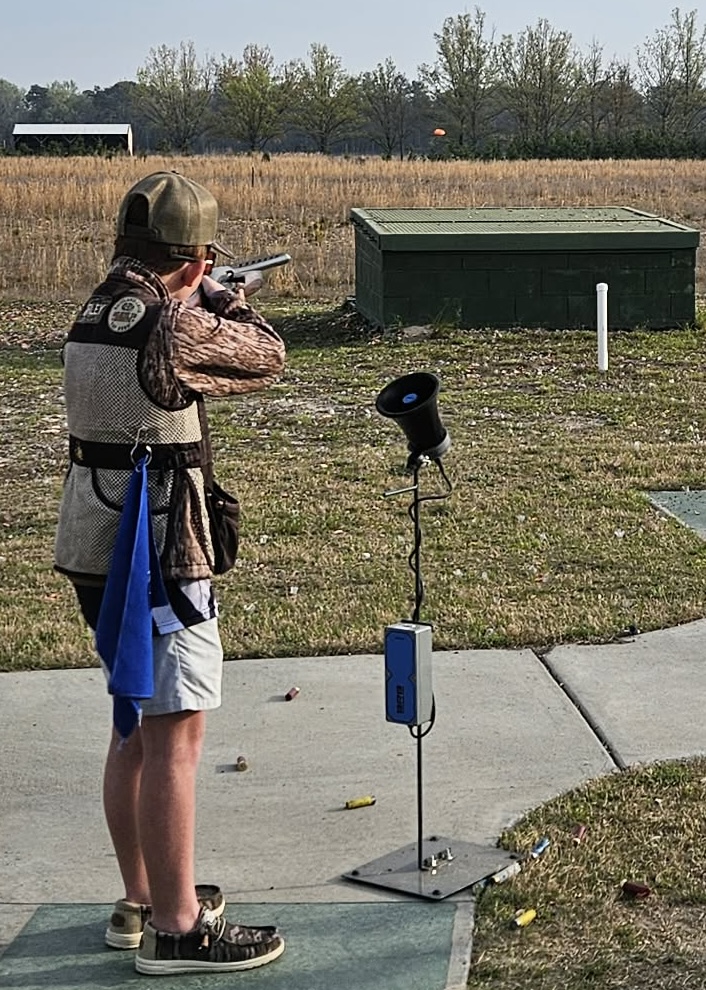Shooter mounted on a trap station next to the target call microphone