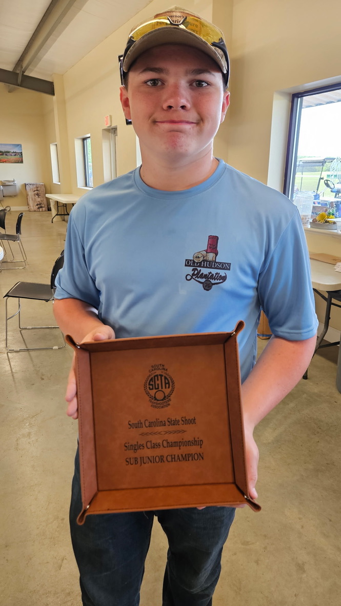 Shooter holding a South Carolina State Shoot Singles Class Sub Junior Champion award tray