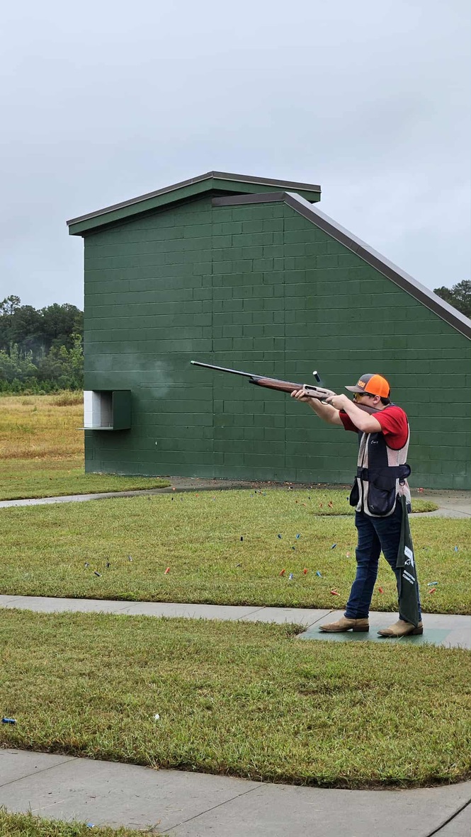 Shooter in a vest calling for a target on the trap field
